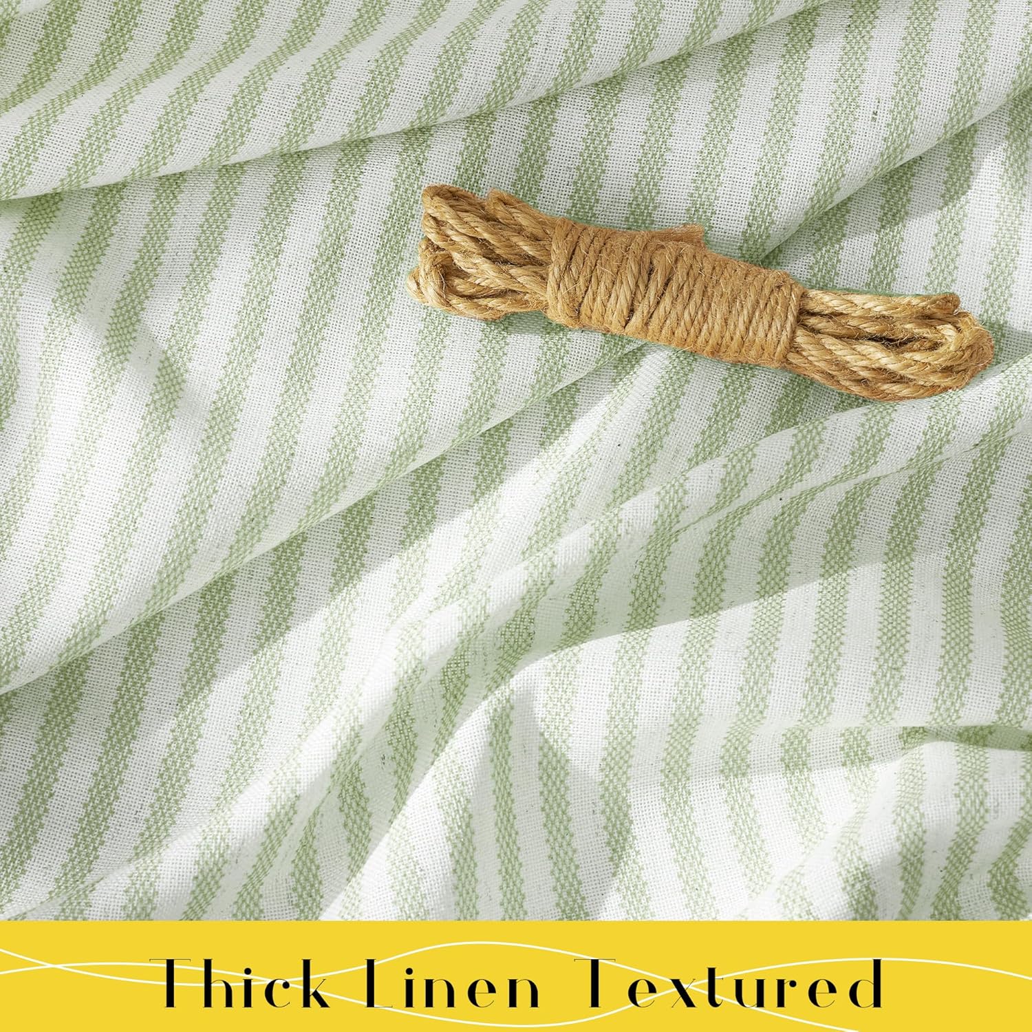 Thick linen textured fabric with woven sage green and white vertical stripes, draped in soft folds.