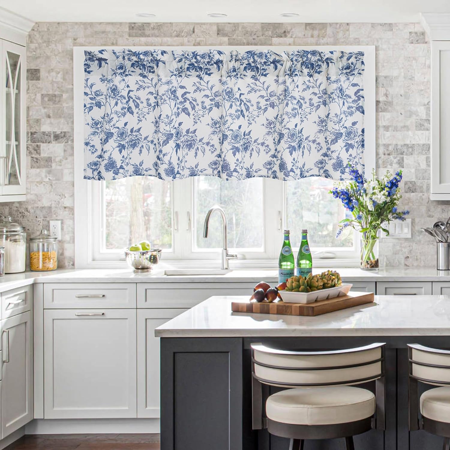 Blue and white floral toile valance with gathered top hangs over a kitchen window.