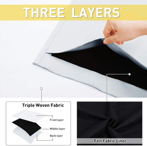 Hand pulling light grey triple-layer fabric, revealing black felt blackout liner construction.