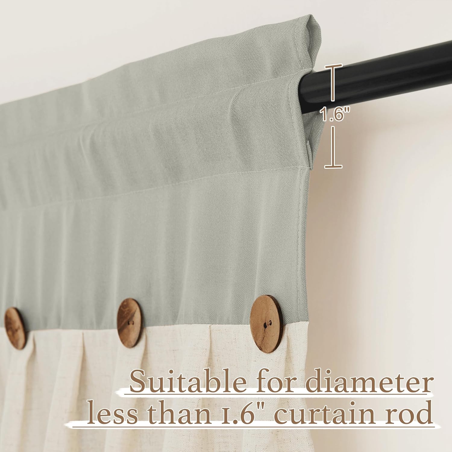 Sage green and cream two-tone curtain featuring decorative wooden buttons. Hung on a black rod.