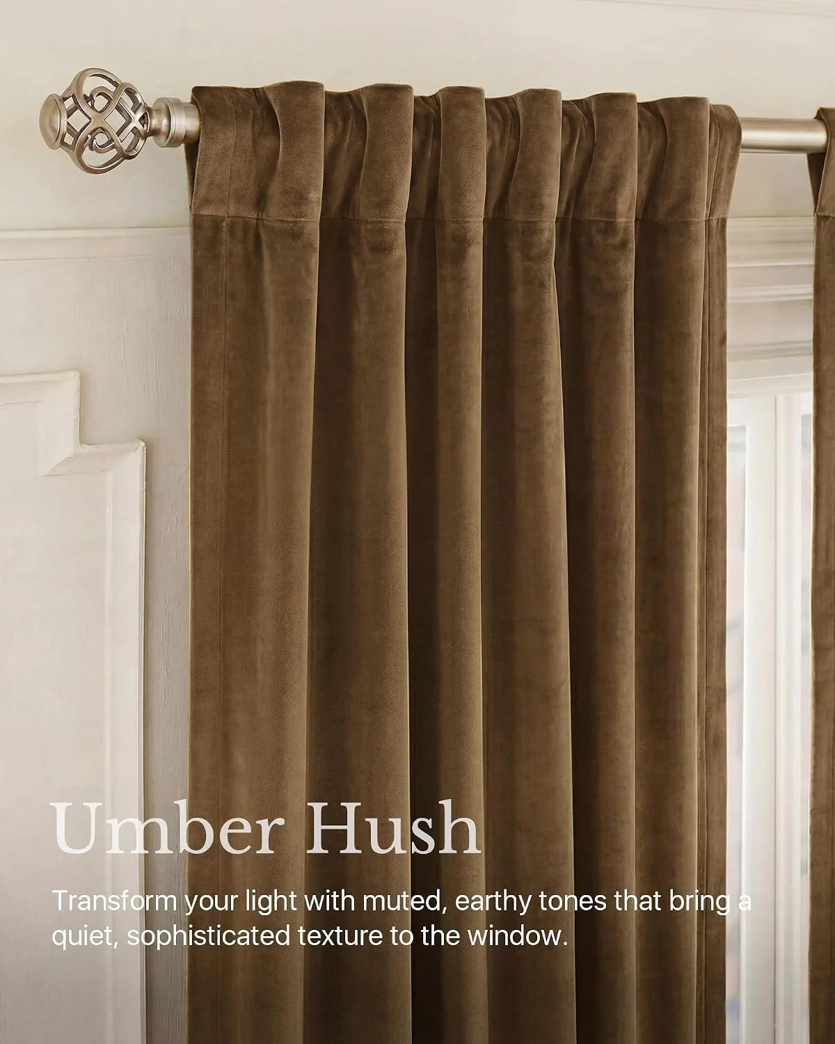 Umber velvet pleated curtain panel on a brushed silver rod in a classic room