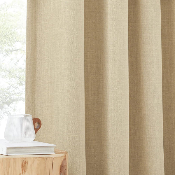 Warm beige textured linen blend curtain panel hanging by a window, with a book and glass mug on a wooden table.