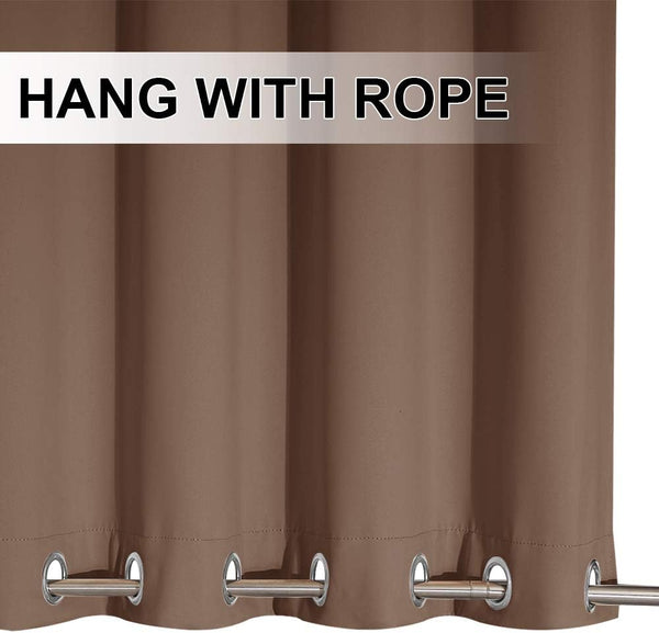 Close-up of a warm brown smooth fabric curtain with silver metal grommets, hanging from a rod.