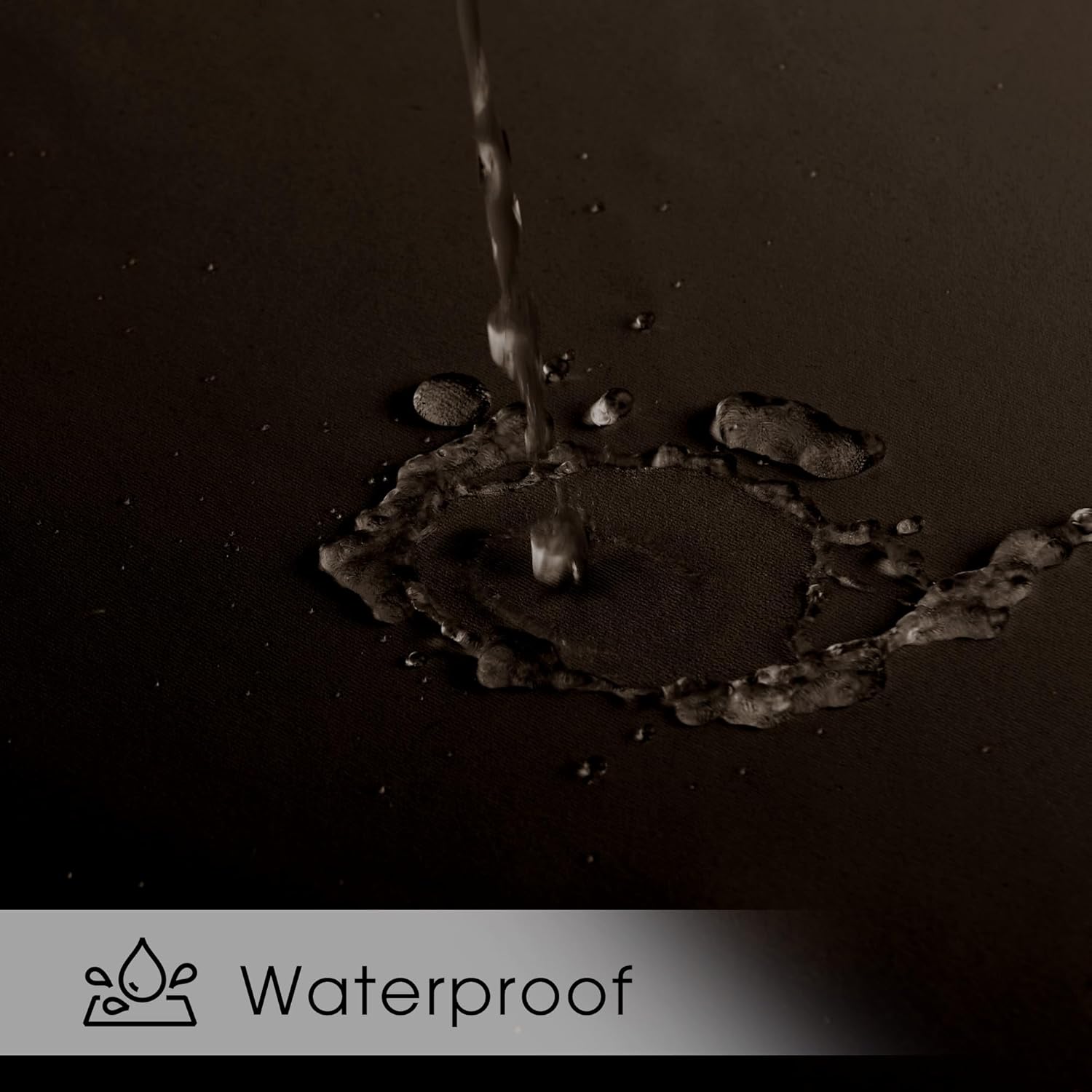 Stream of water pouring onto a dark, possibly black, fabric surface, showing excellent water repellency and beading.