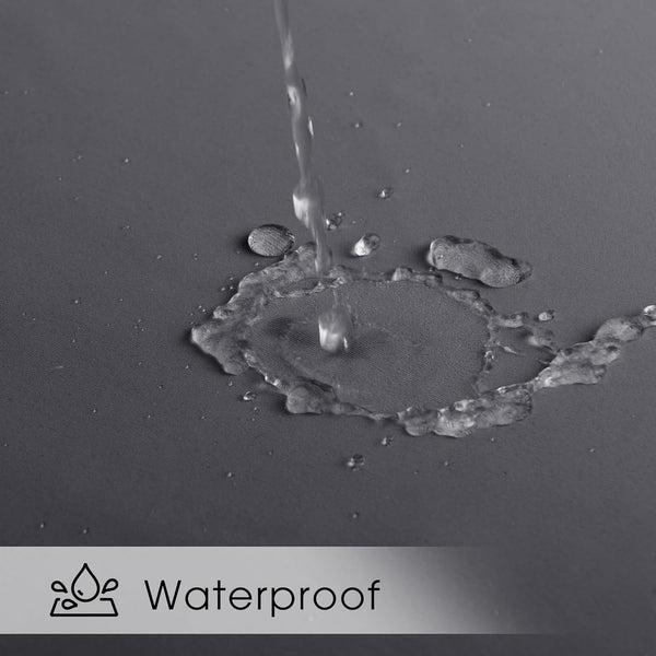 Water streams onto a dark gray textured fabric, beading up to demonstrate its waterproof quality.
