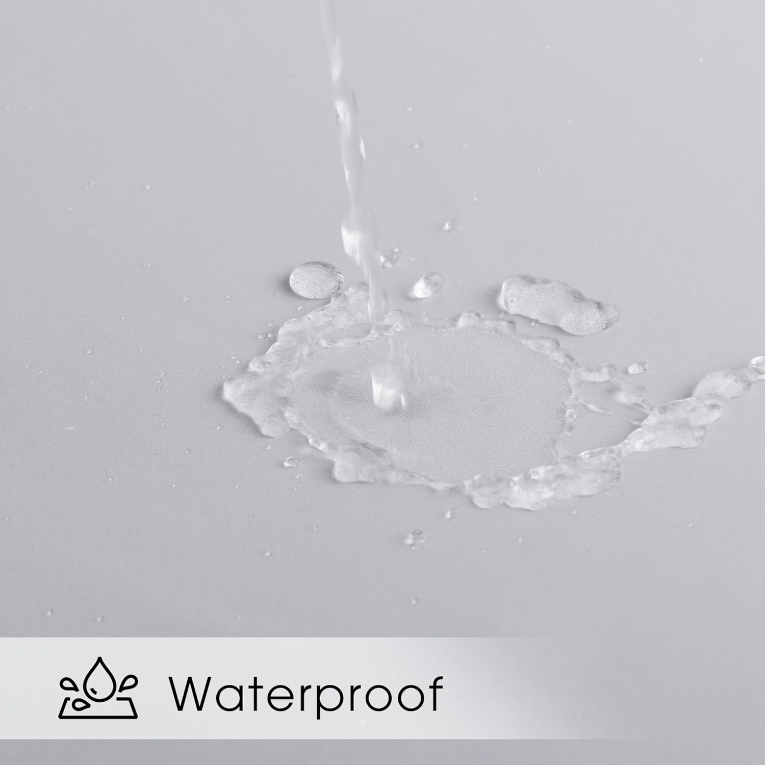 Close-up of water beading and repelling on a light gray fabric surface, highlighting its waterproof feature.