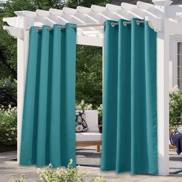 Teal weatherproof outdoor curtains with grommet tops hanging on a white pergola over a patio.
