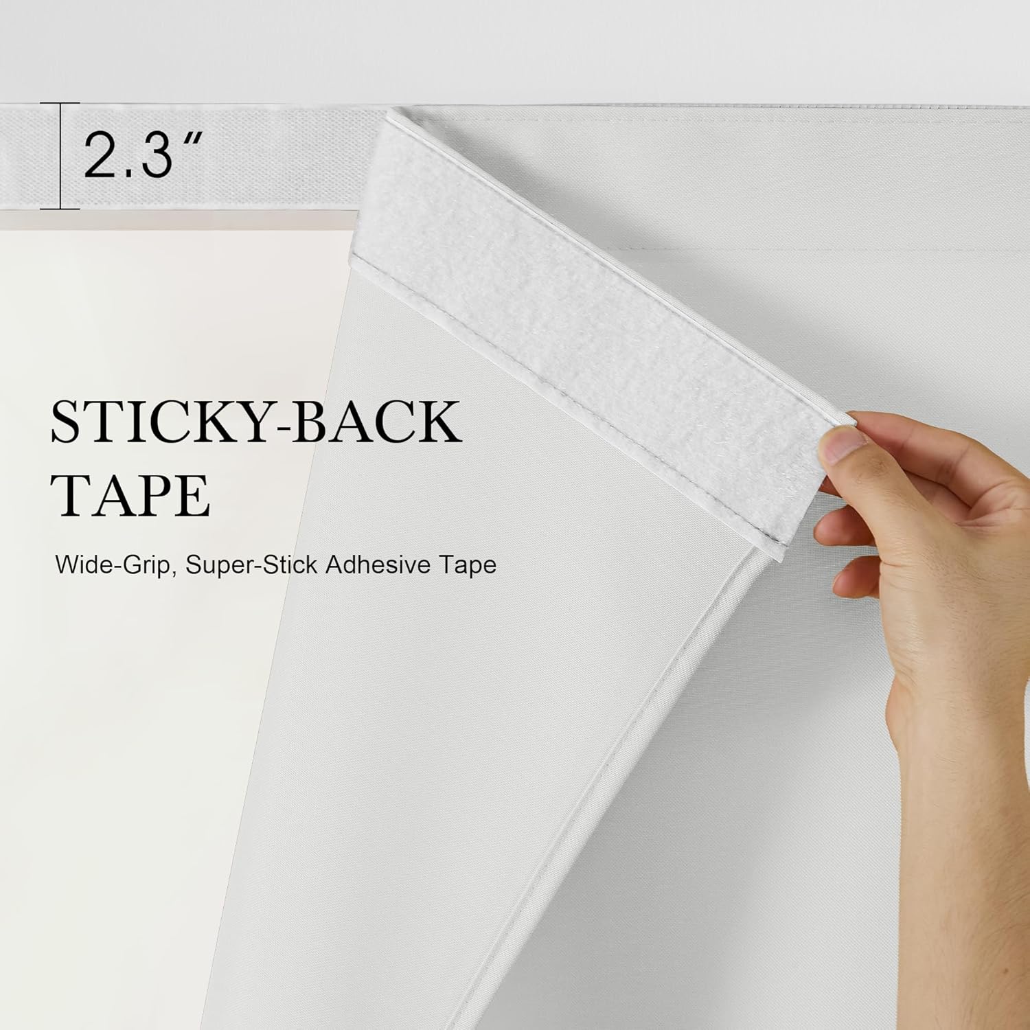 Close-up of a hand revealing the 2.3-inch wide white sticky-back adhesive tape on a light grey curtain.