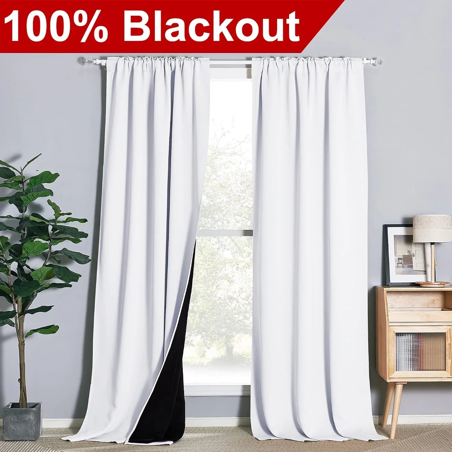 White blackout curtains with black lining on a window in a modern room