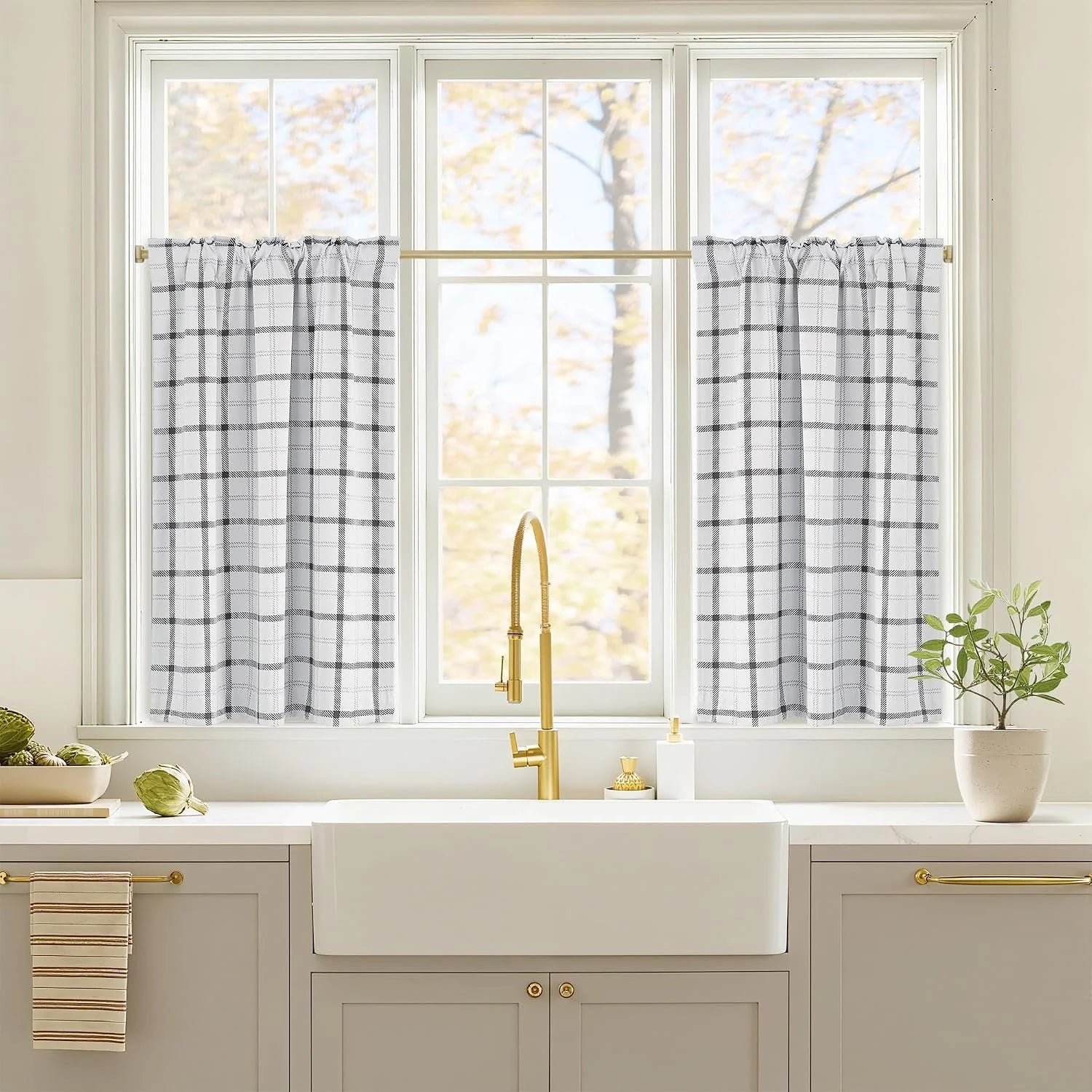 White and black plaid cafe curtains over a bright kitchen sink window