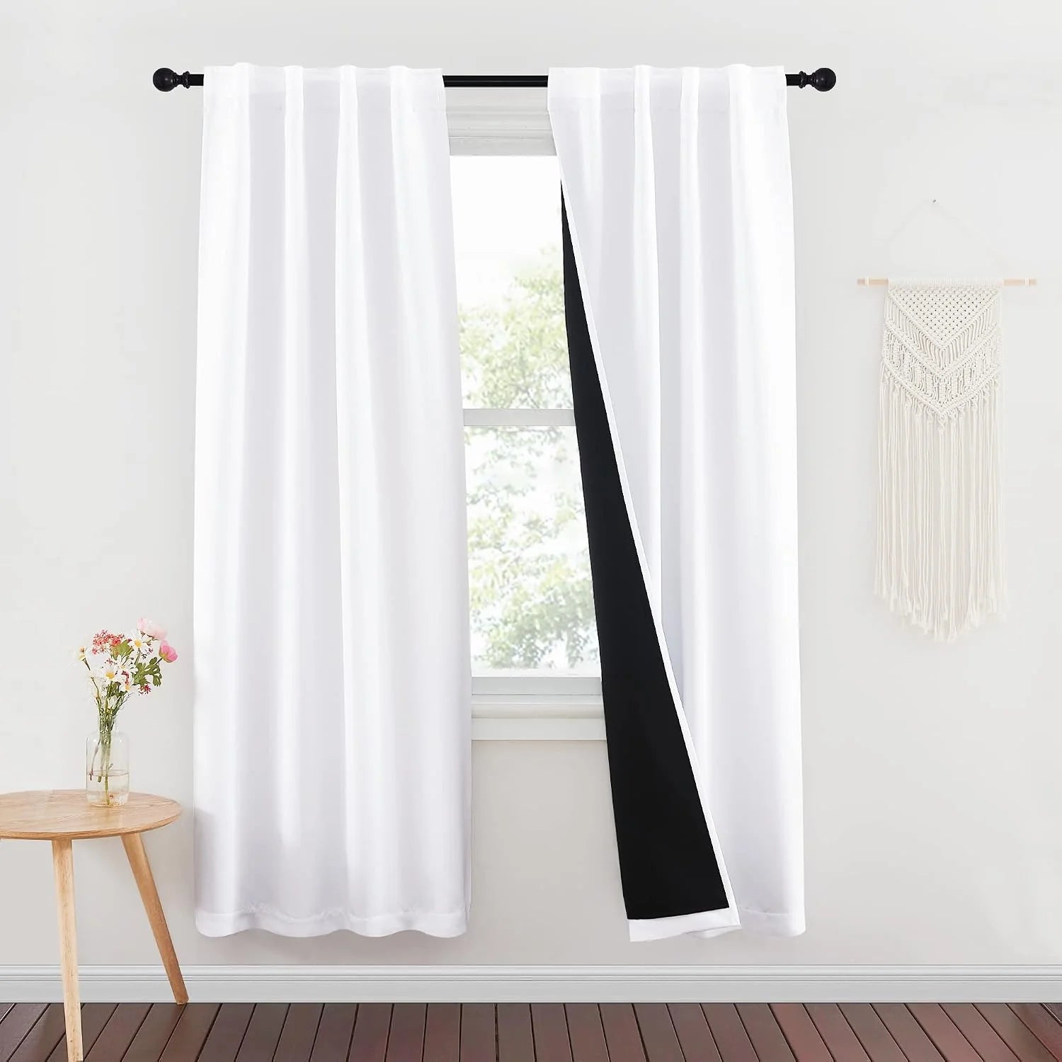 White rod pocket blackout curtains with black lining on a bright minimalist window
