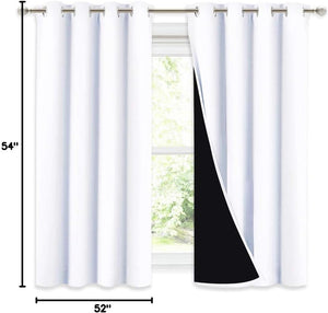 White blackout grommet curtains, 54x52 inches, reveal black lining, hanging on a silver rod.