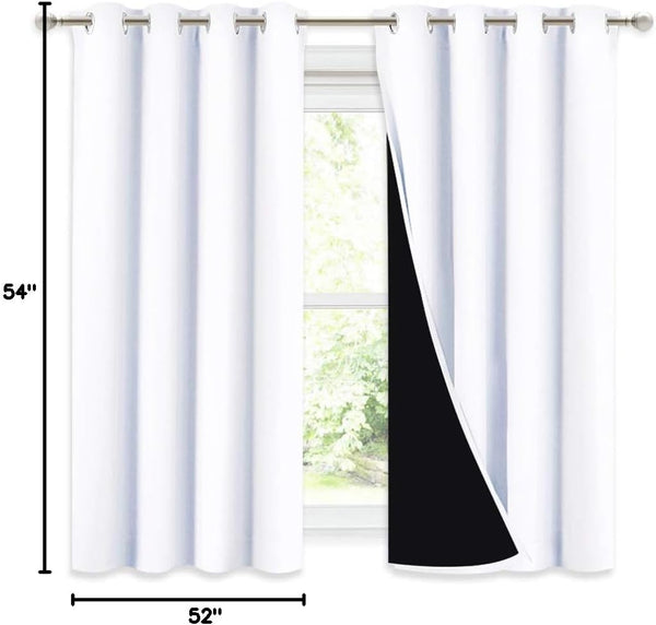 White blackout grommet curtains, 54x52 inches, reveal black lining, hanging on a silver rod.