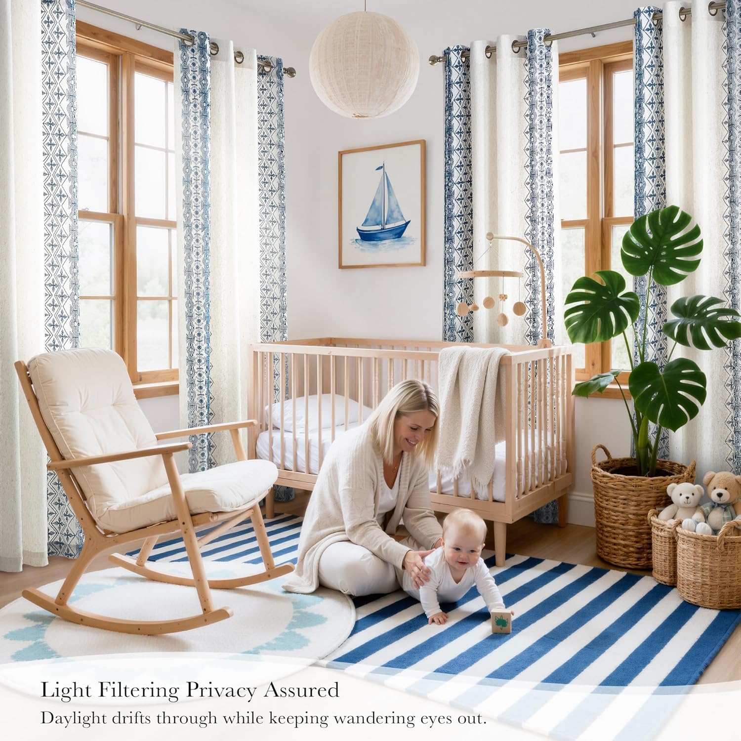 White and blue geometric light filtering curtains with grommet tops in a baby nursery.