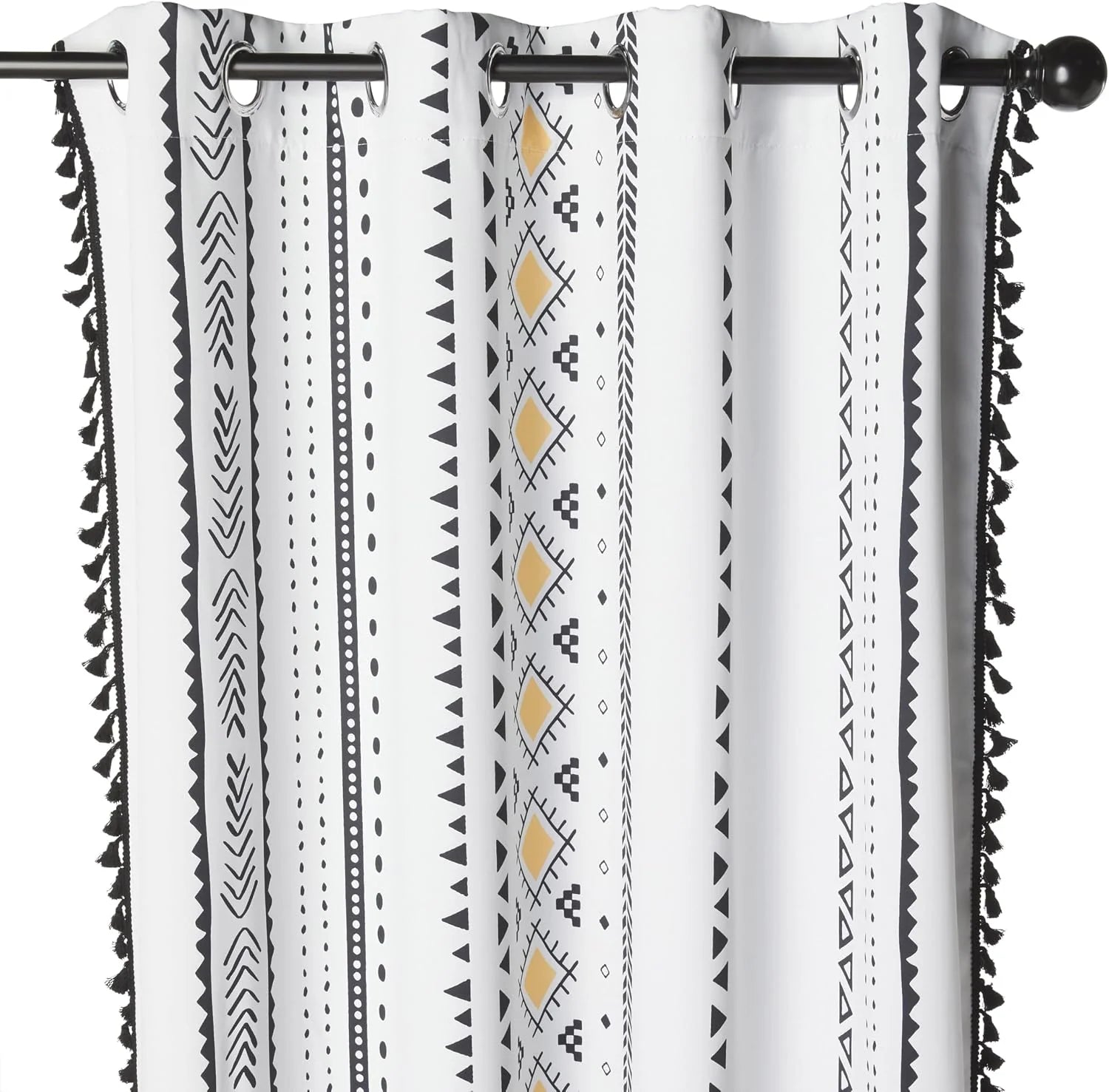 White boho curtain with black geometric print, yellow accents, and tassel trim