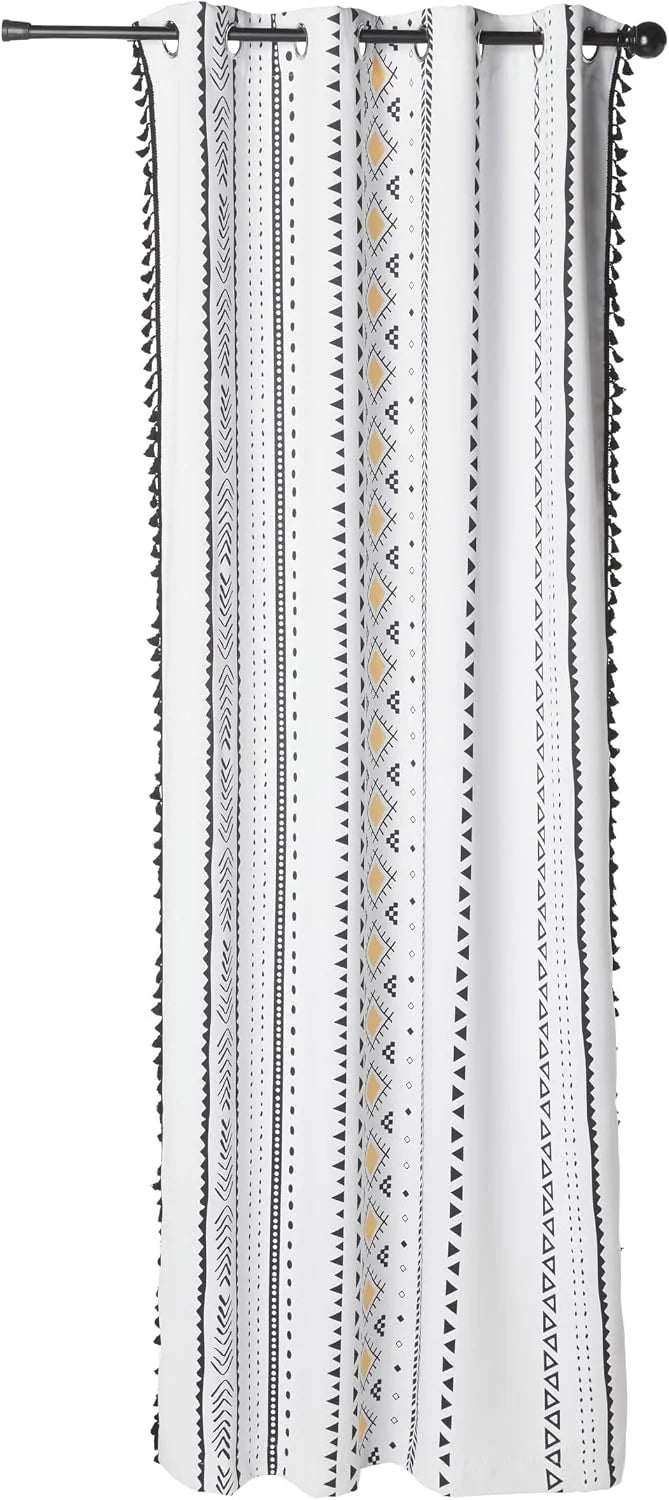 White boho curtain with black geometric stripes, mustard accents, and tassel trim