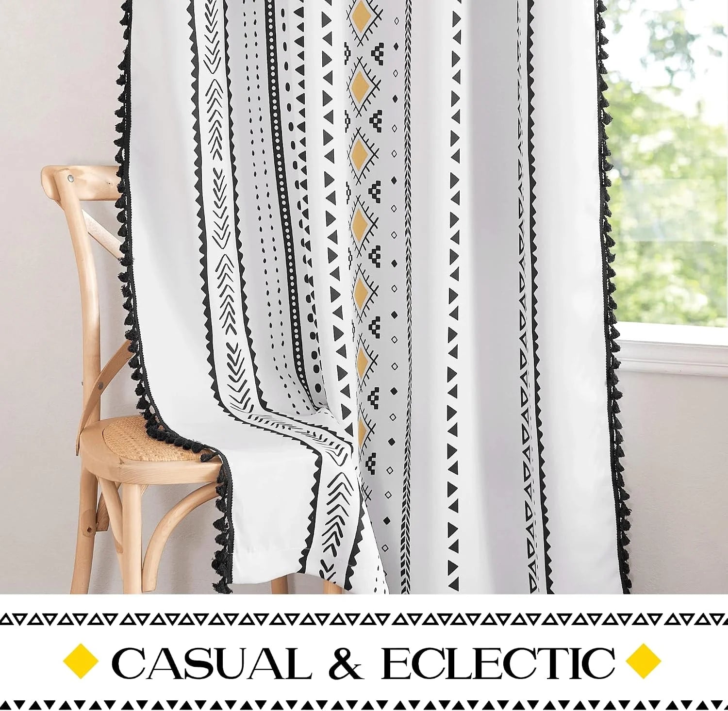 White boho curtain with black geometric print and tassel trim by a bright window