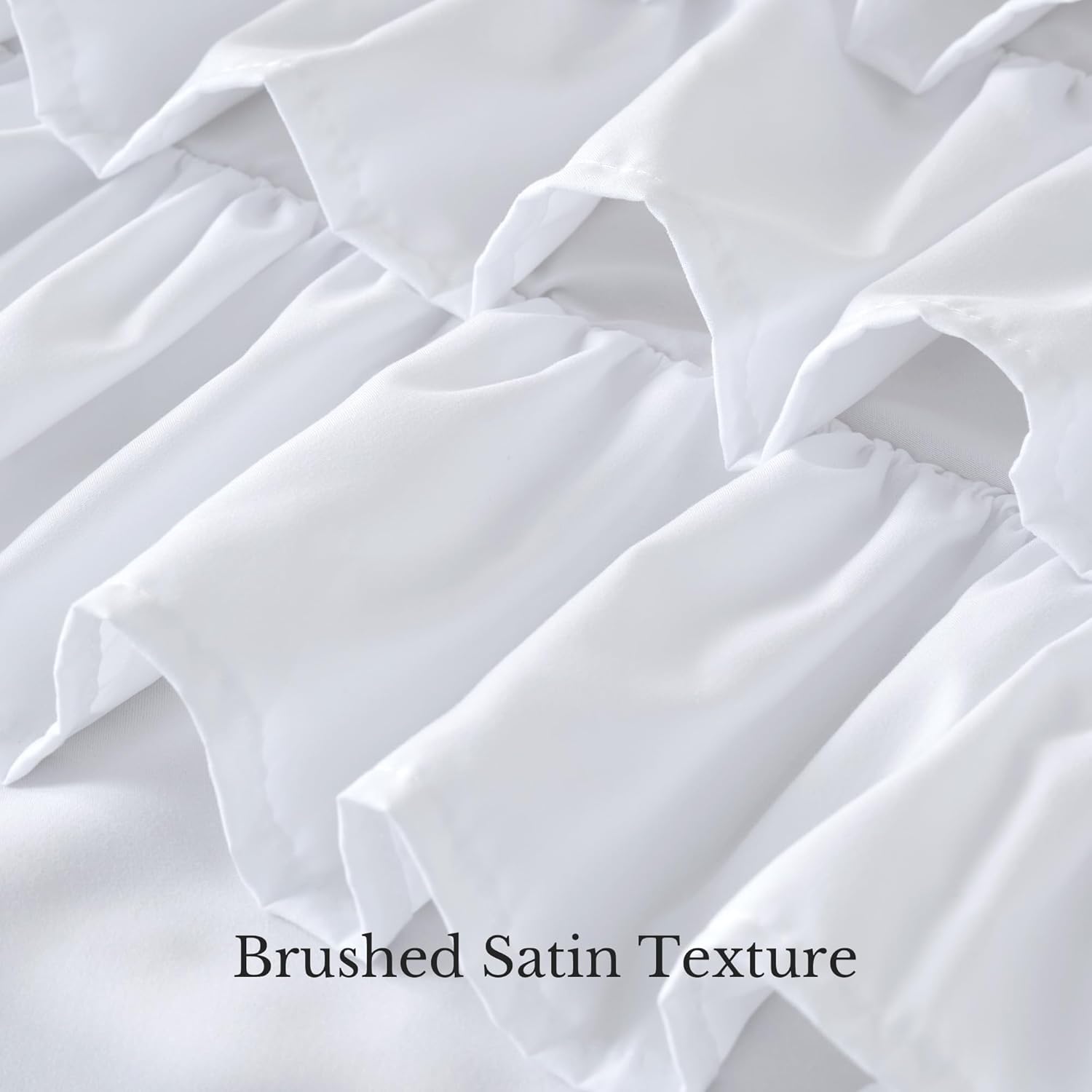 Close-up of white brushed satin fabric featuring multiple soft, layered ruffles and gathers.