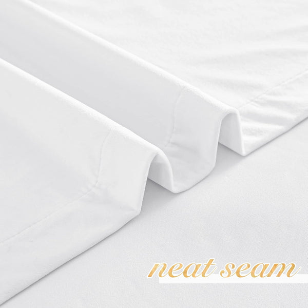 Crisp white fabric with a finely finished, neat seam along the hem, highlighting quality stitching.