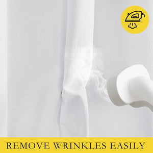 Close-up of white textured curtain fabric being smoothed by a handheld steamer, showing easy wrinkle removal.