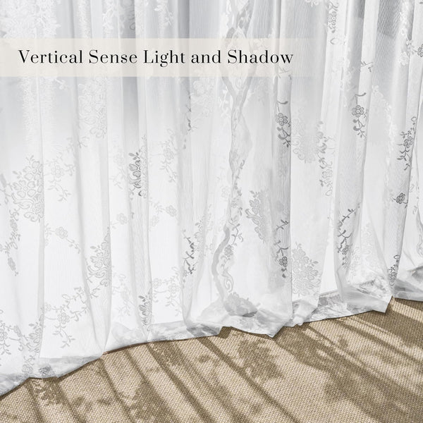 White sheer curtains with delicate floral embroidery, sunlight creating shadows on the floor.