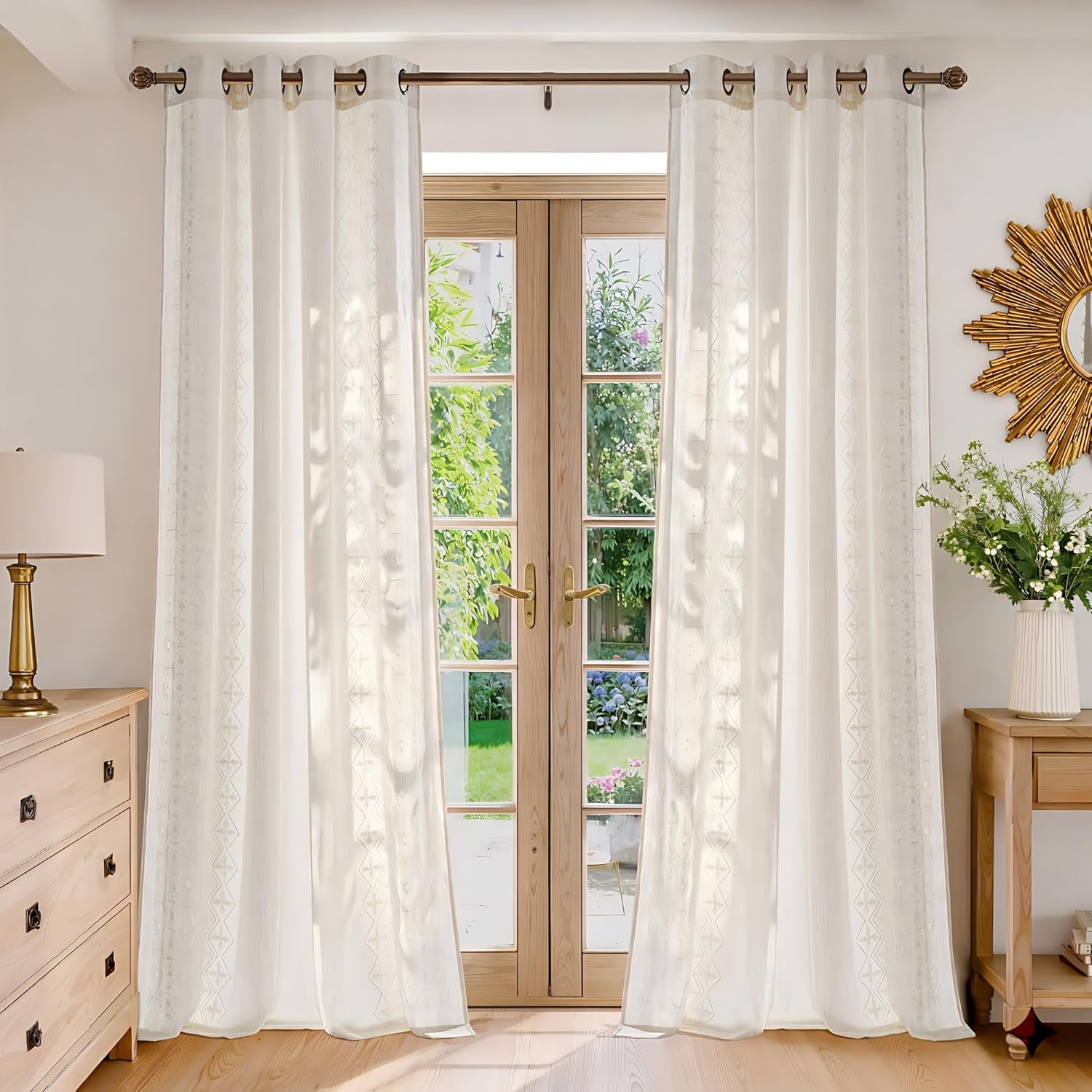 White semi-sheer grommet top curtains with subtle geometric embroidered pattern