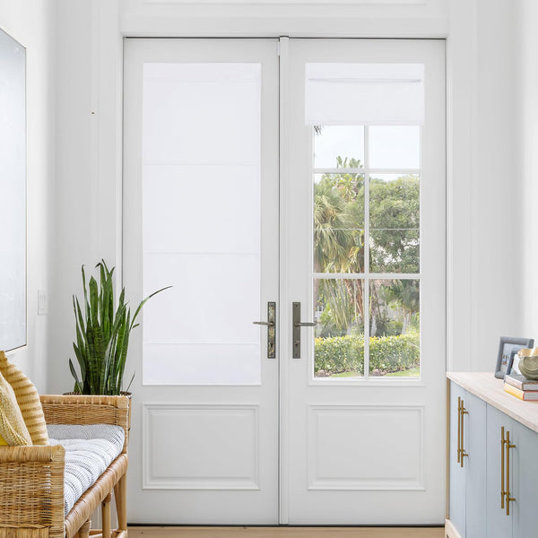Clean white fabric window privacy shades covering the upper glass panels of double white doors.