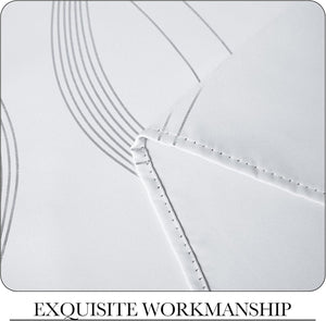 Close-up of white textured fabric with a modern gray wavy line pattern, highlighting precise double-stitched seams.