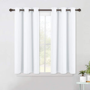 Two white fabric grommet top curtains hanging on a dark bronze rod over a window.