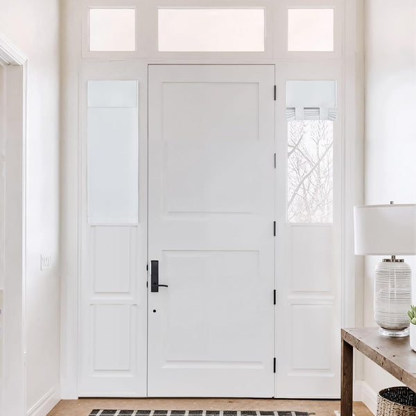 White fabric privacy shade partially lowered on a modern white door sidelight.