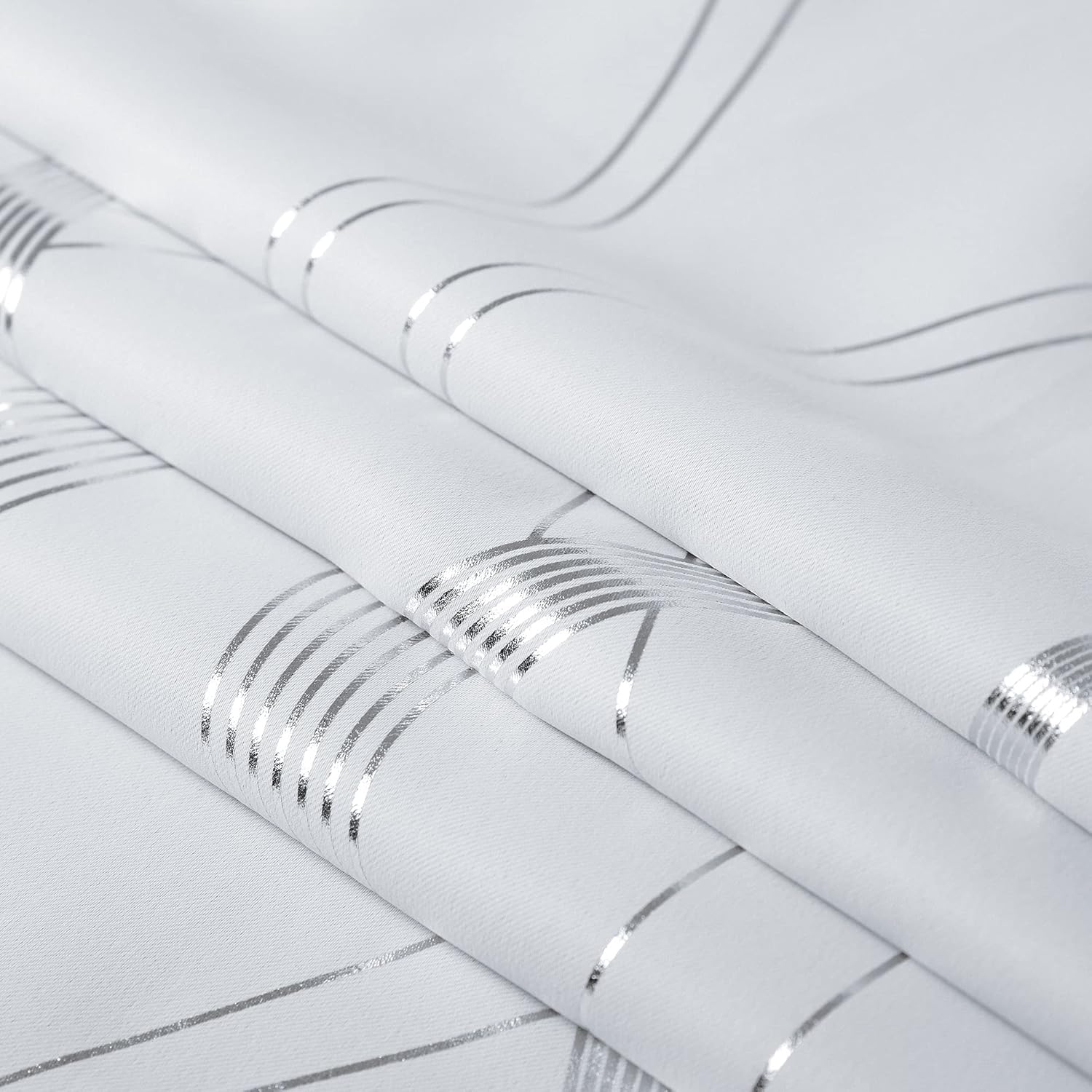 White woven fabric featuring a modern pattern of shimmering silver stripes and intersecting lines.