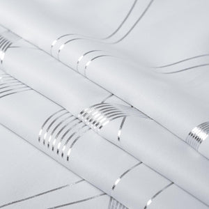 White woven fabric featuring a modern pattern of shimmering silver stripes and intersecting lines.