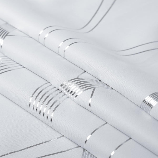 White woven fabric featuring a modern pattern of shimmering silver stripes and intersecting lines.