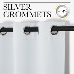 Close-up of white fabric curtains with shiny silver 1.6-inch grommets on a black rod.