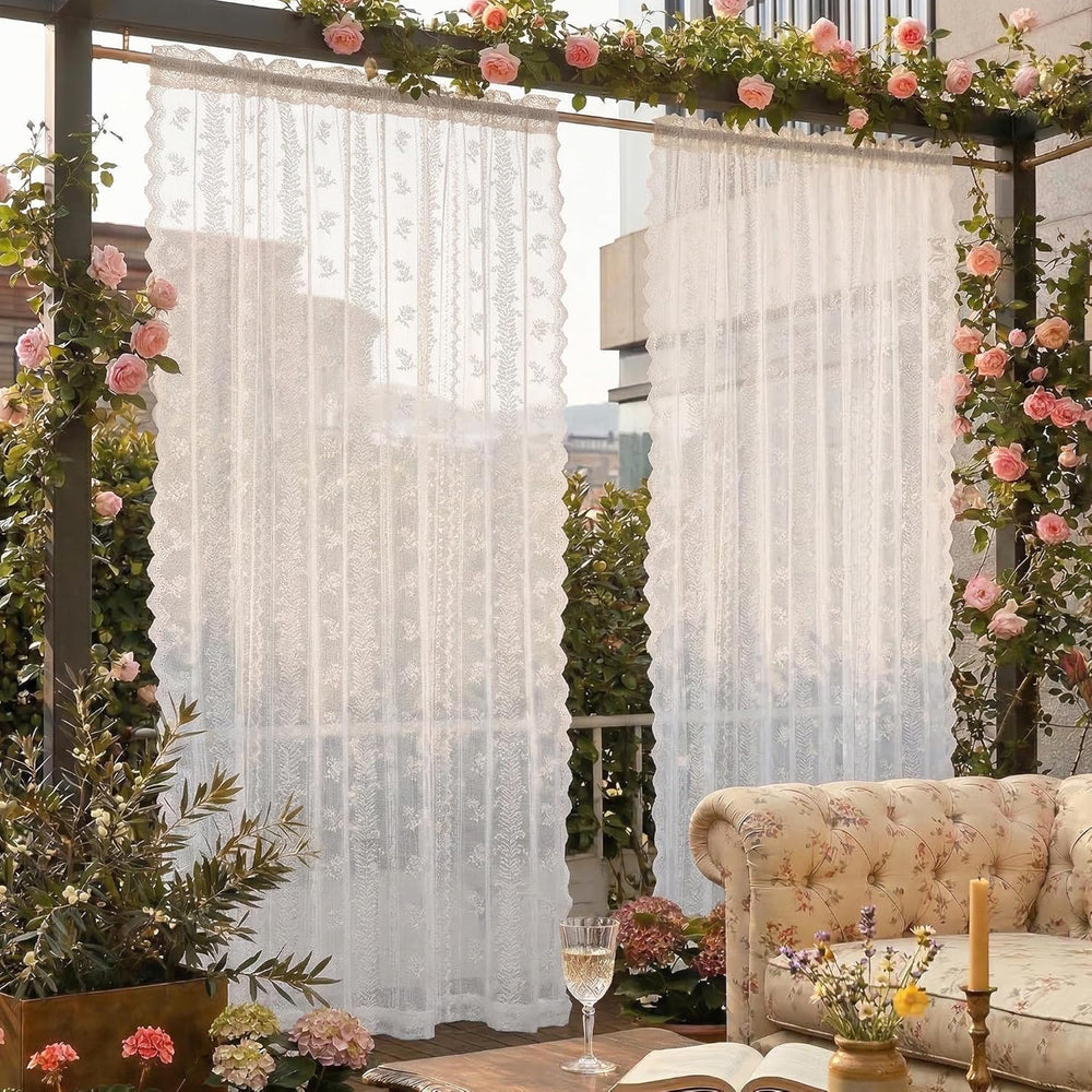 White sheer lace curtains with floral pattern and scalloped edges, on a romantic outdoor patio.