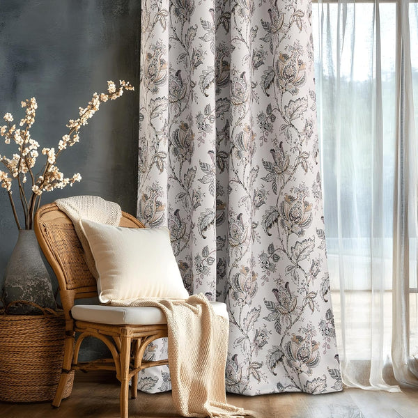 White room darkening curtain with intricate floral paisley pattern, grommet top, in a cozy interior.