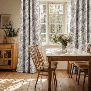 Elegant white curtains with intricate brown and grey floral pattern in a rustic dining room setting.