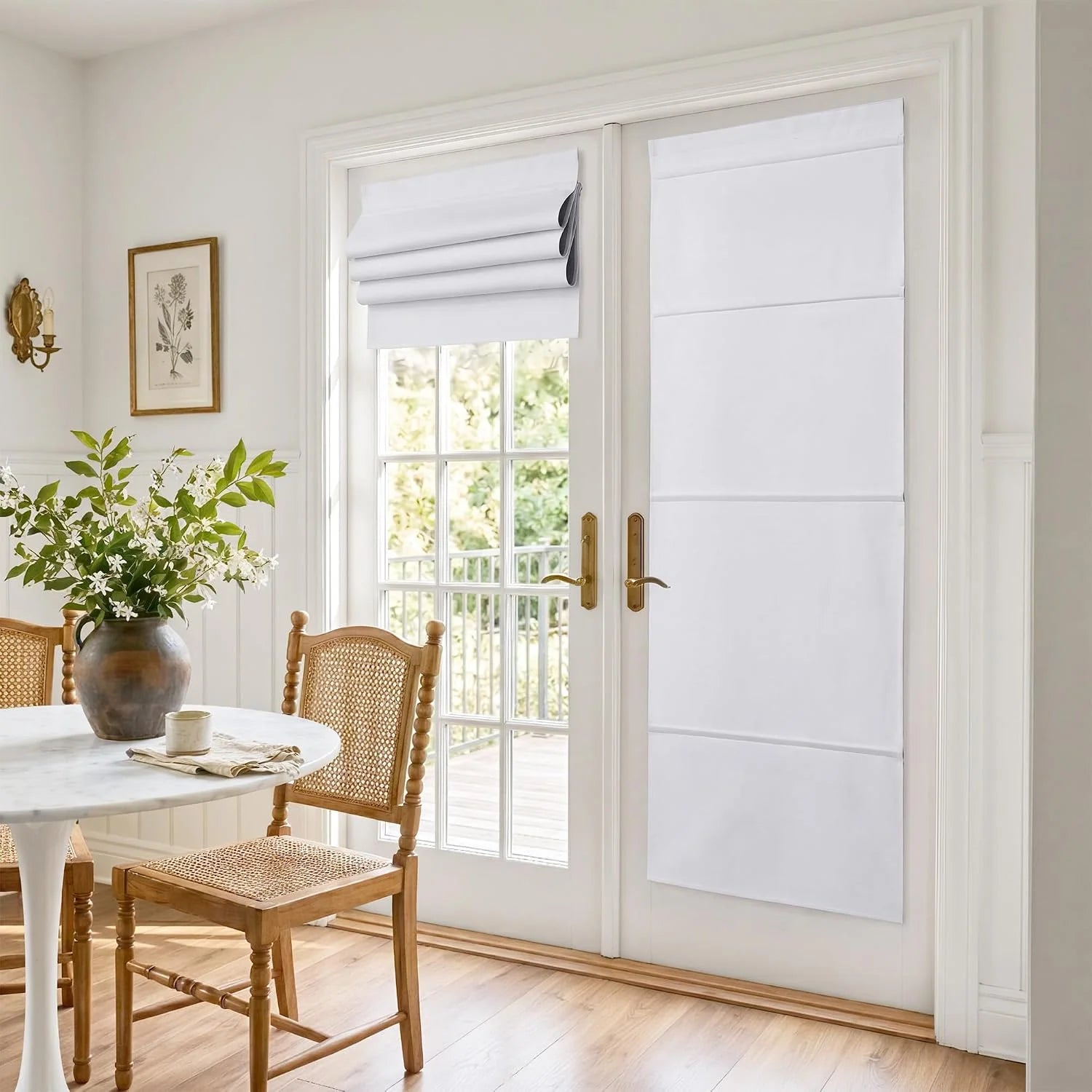 White Roman shades on French patio doors in a bright dining room with cane chairs
