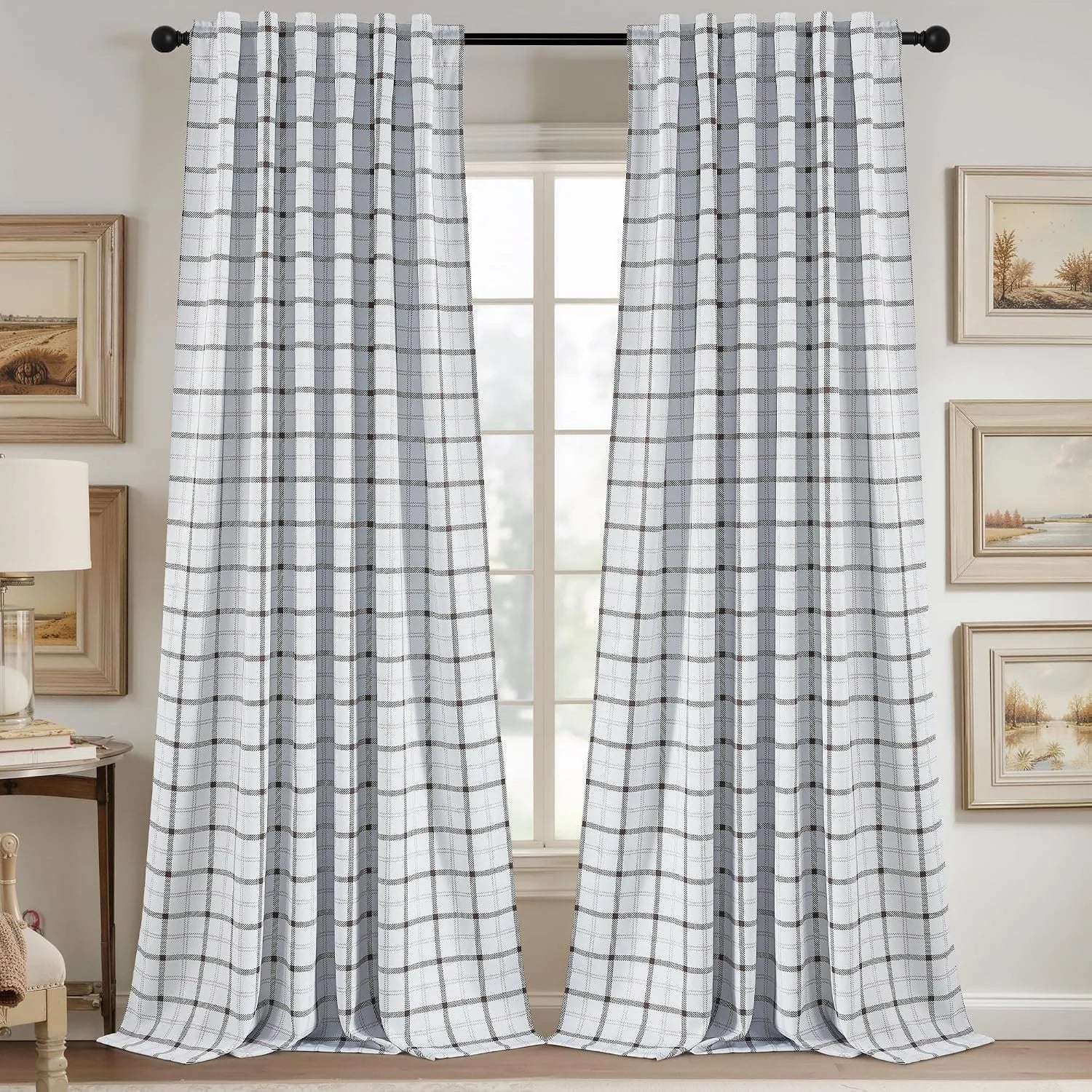 White and gray plaid curtains hanging on a black rod in a cozy neutral room