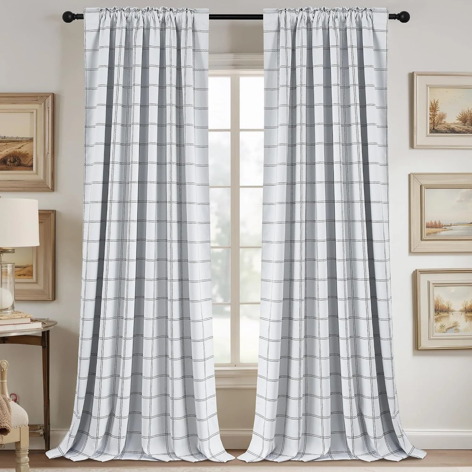 White and gray windowpane curtains hanging on a black rod in a neutral room