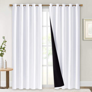 Pair of white grommet curtains with visible black thermal blackout lining on a window.