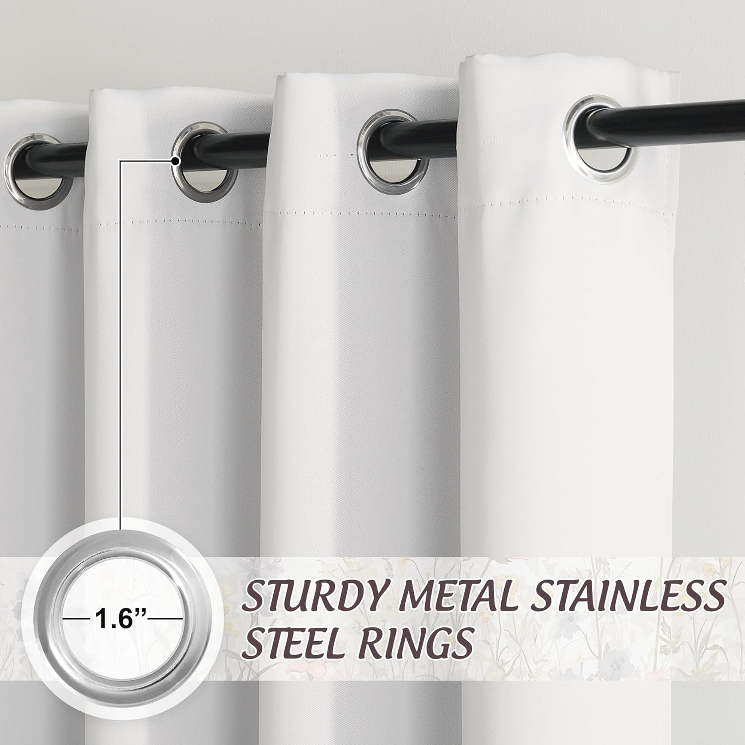 Close-up of white grommet top curtains with sturdy 1.6-inch stainless steel rings on a black rod.