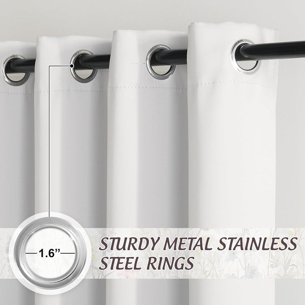 Close-up of white grommet top curtains with sturdy 1.6-inch stainless steel rings on a black rod.