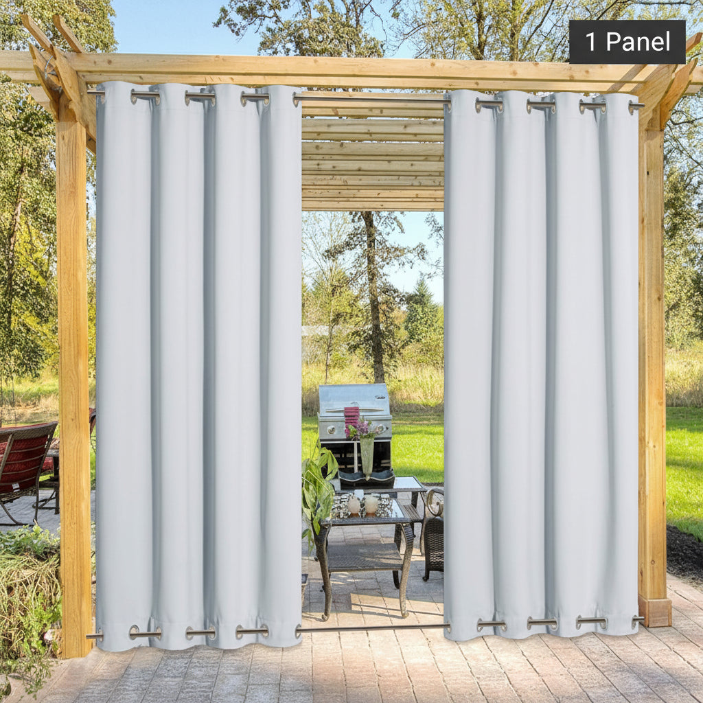 Two panels of white grommet top outdoor curtains hanging on a wooden pergola, showing a patio.