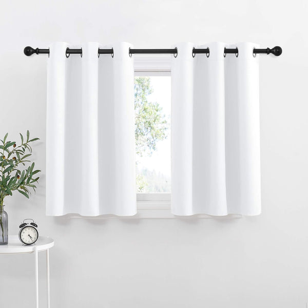 Crisp white tier curtains with black grommet tops hanging on a black rod, enhancing a bright window.