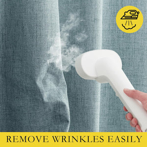 White handheld steamer emits steam, smoothing wrinkles from light blue textured linen fabric panel.
