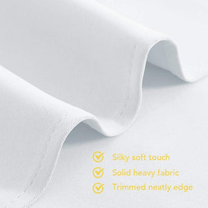Close-up of smooth white fabric, highlighting its silky texture, heavy drape, and neat stitching along the edge.