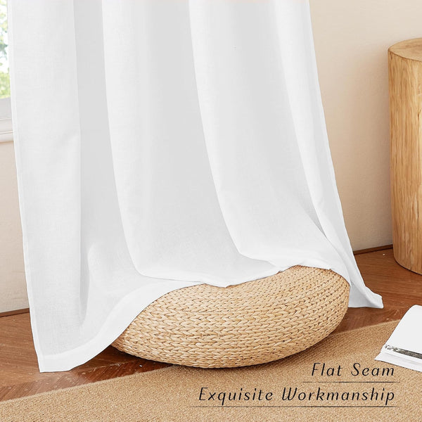 White linen blend sheer curtain with neat flat seam, draped over woven pouf in bright, natural room.