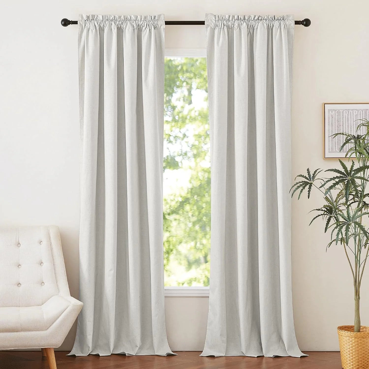 White linen-look rod pocket curtains hanging in a bright modern living room window
