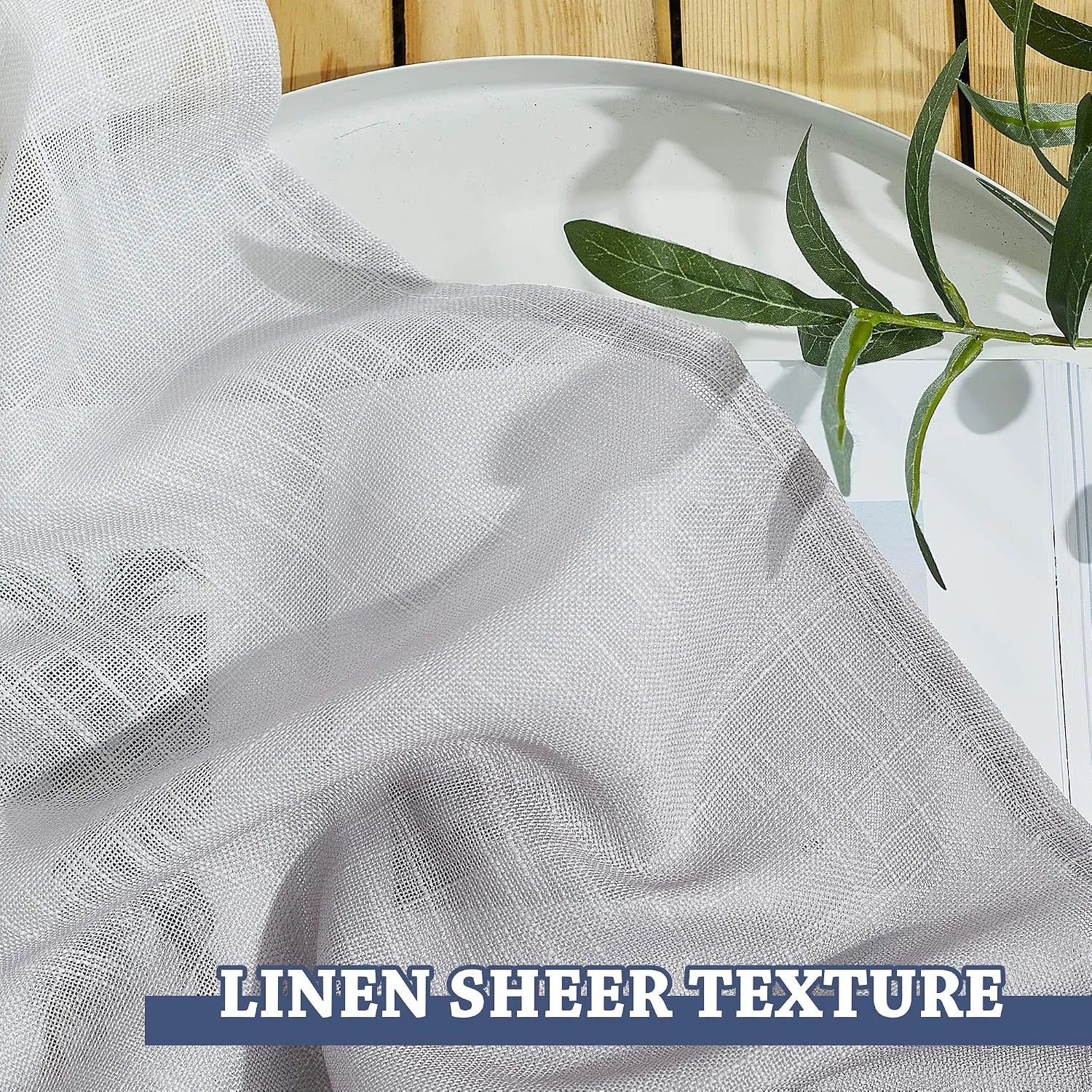 White linen sheer curtain fabric draped on a tray with soft woven texture